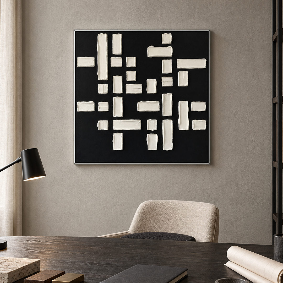 black and white geometric textured wall art with raised blocks in a coordinated modern interior