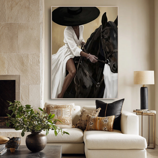 elegant black horse and cowgirl wall art in cream and white displayed in a styled living room