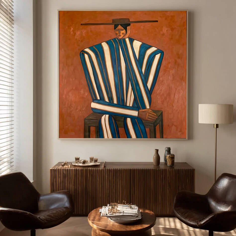 folk Western figurative wall art in blue white and burnt orange displayed in a styled living room