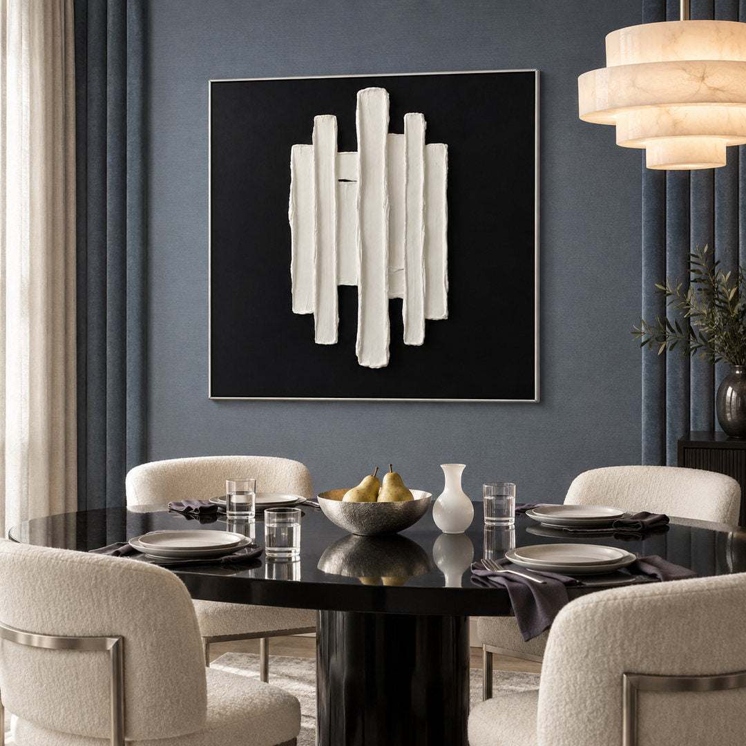 black and white sculptural wall art with vertical raised pillars in a coordinated modern interior