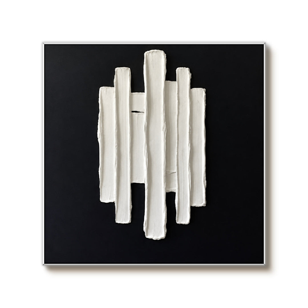 black and white sculptural wall art with vertical raised pillars on a clean white background
