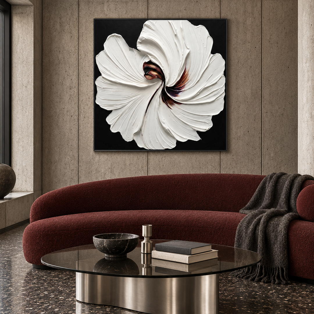 3D textured white floral wall art on black with sculptural petals displayed in a styled living room
